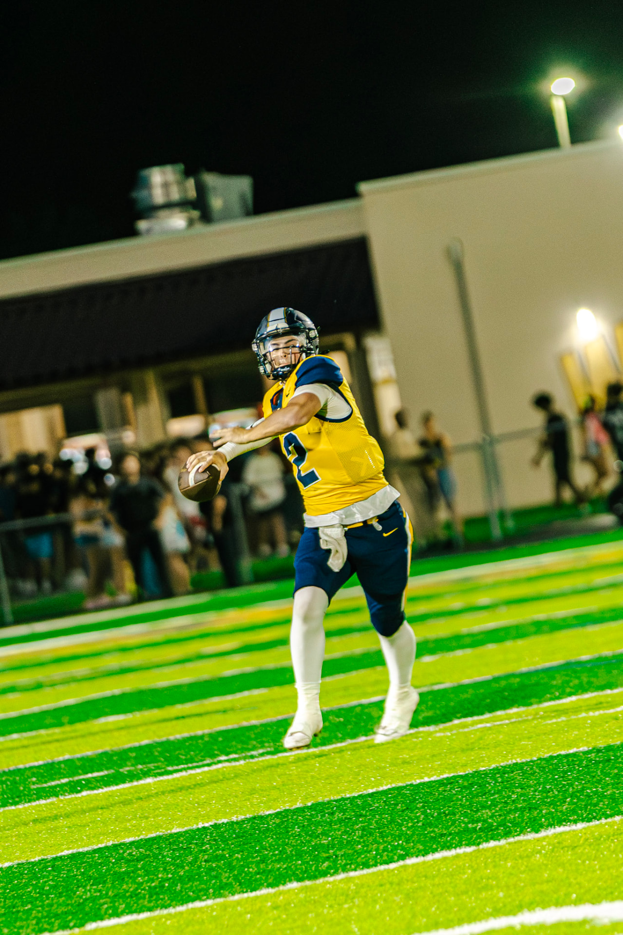 Warriors quarterback scrambling with the ball at night